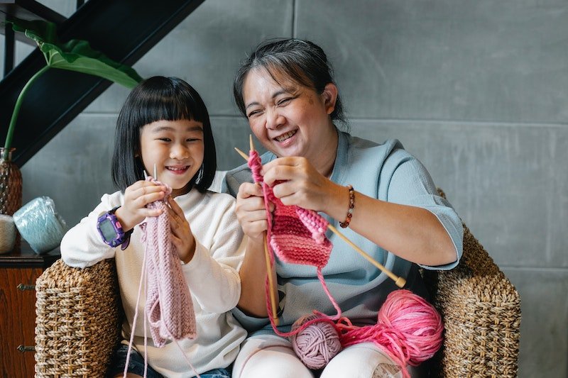 Grandmother and granddaughter knitting - a good craft activity for seniors and older adults with dementia