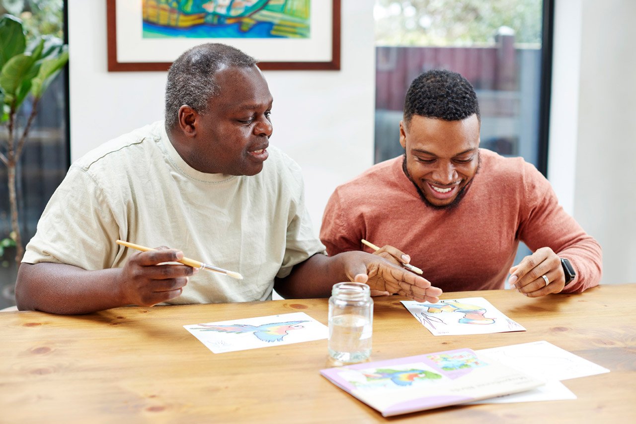 Father and son enjoying painting an Aquapaints scene.