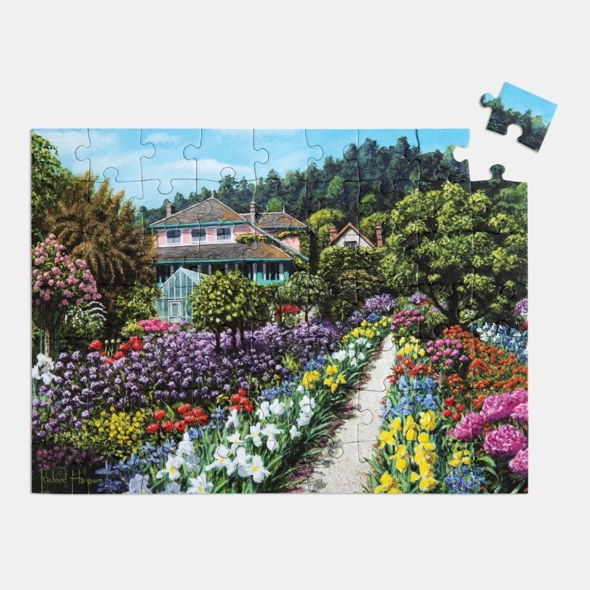 A jigsaw puzzle showing a flowery garden scene. Jigsaw puzzles are great mind-stimulating games for elderly people.