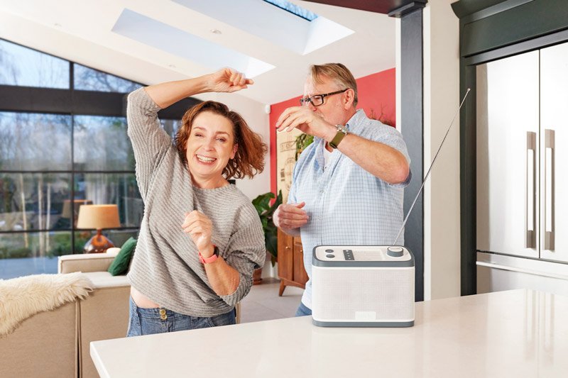 Senior couple with dementia dancing and listening to music